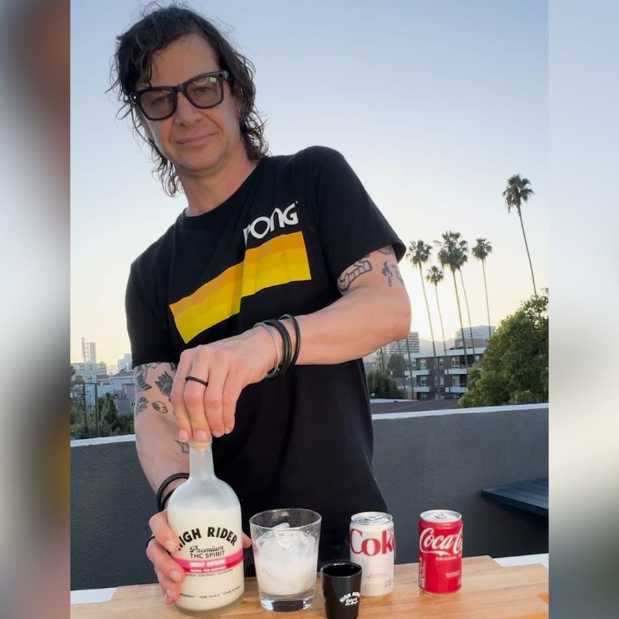 Person pouring High Rider Spirit into a glass on a rooftop