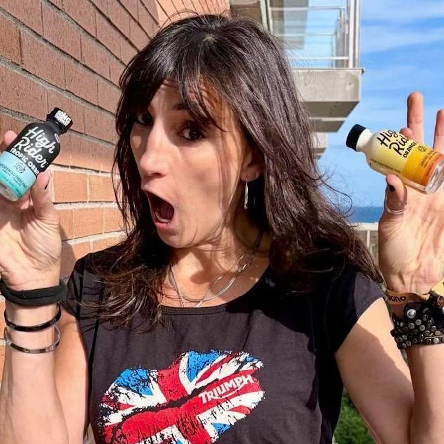 Woman holding two High Rider THC shot bottles